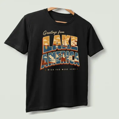 Vintage retro t-shirt with Lake America scene featuring a lighthouse and sailboat — printed on a unisex t-shirt (angled view)