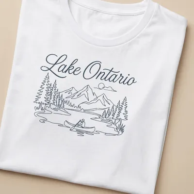 Line-art graphic of a canoeing scene on Lake Ontario in blue and white — printed on a women's shirt