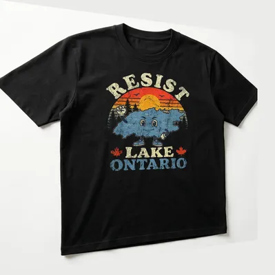 Retro distressed shirt featuring Lake Ontario character with colorful sunset design — printed on a unisex t-shirt (angled view)