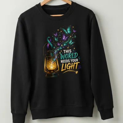 Colorful illustration of a lantern with butterflies and the text 'This World Needs Your Light' — printed on a unisex sweatshirt