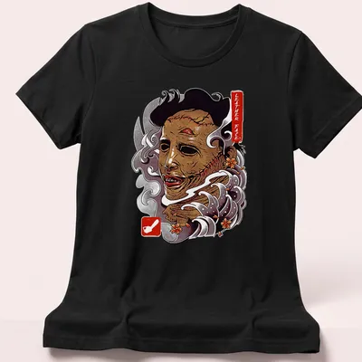 Vintage horror t-shirt featuring Leather Face graphic in brown, white, red, and gray — printed on a women's shirt