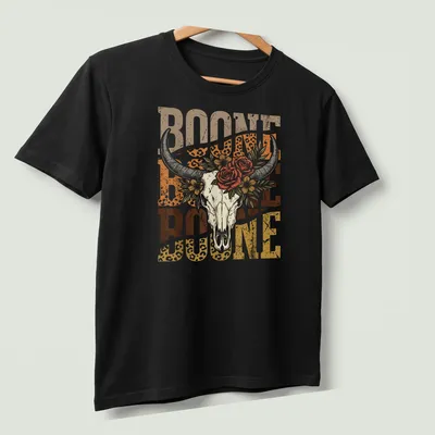 Vintage floral design with longhorn skull and the text Boone Boone Boone — printed on a unisex t-shirt (angled view)