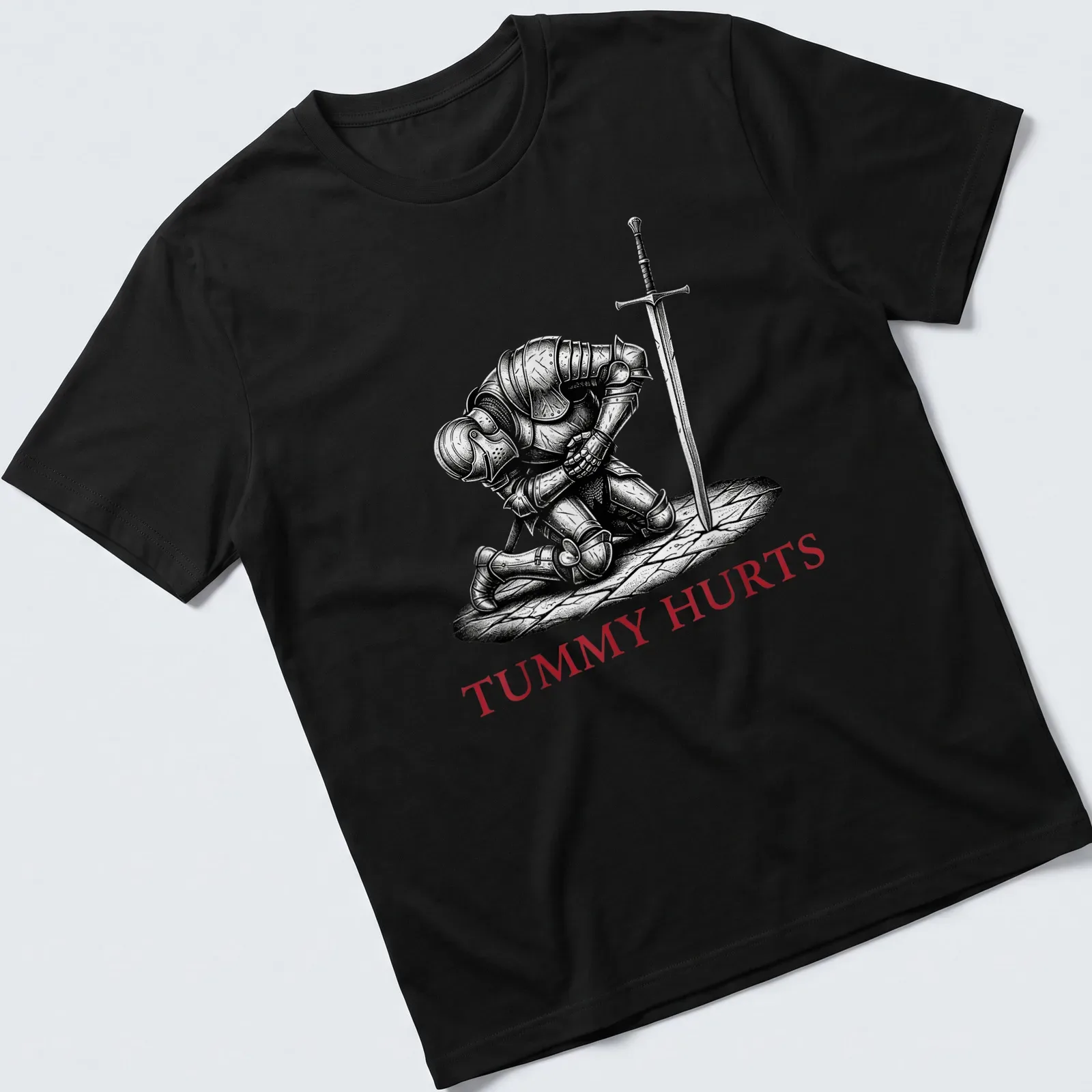 Dark humor T-shirt featuring a Medieval knight with the text 'TUMMY HURTS' in black, white, and red. — printed on a unisex t-shirt
