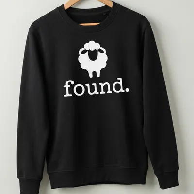 Minimalist black and white sheep icon with the word 'Found.' below. — printed on a unisex sweatshirt