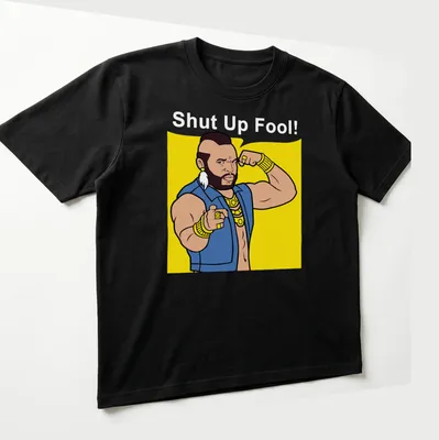 Cartoon Mr. T with the phrase 'Shut Up Fool!' in bright colors — printed on a unisex t-shirt (angled view)