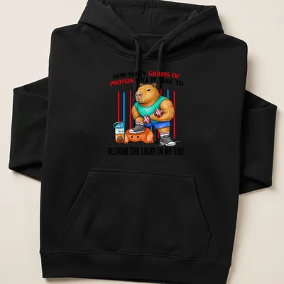 Colorful cartoon of a muscular capybara lifting weights with protein text — printed on a unisex hoodie