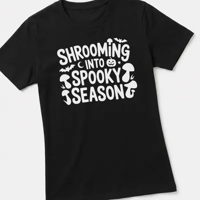 Playful cartoon design of mushrooms for spooky season with vibrant colors — printed on a women's shirt