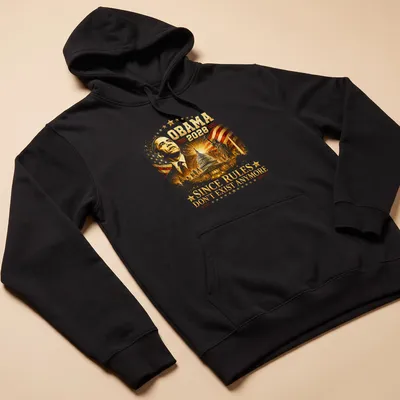 Satirical T-shirt featuring Obama 2028 text in red, white, blue and gold — printed on a unisex hoodie