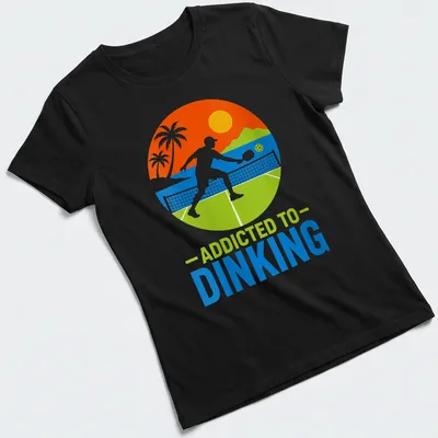 Tropical style tee featuring pickleball themed text in bright colors — printed on a women's shirt