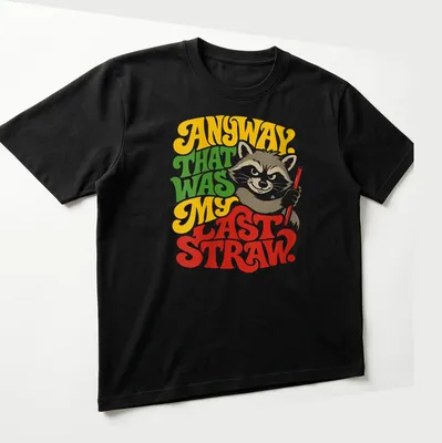 Colorful illustration of a raccoon with humorous text about frustration — printed on a unisex t-shirt (angled view)