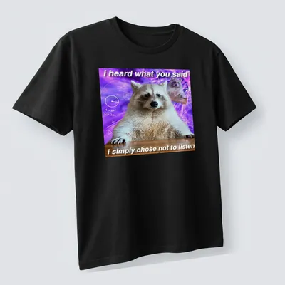 Funny raccoon meme t-shirt featuring humorous text with a cartoon raccoon — printed on a unisex t-shirt (angled view)