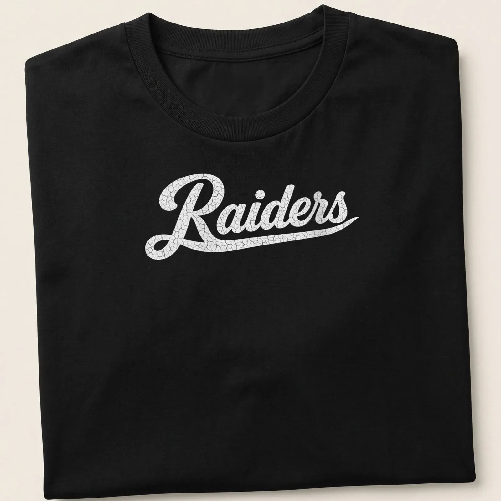 Vintage Raiders t-shirt with bold printed text and distressed design — printed on a unisex t-shirt