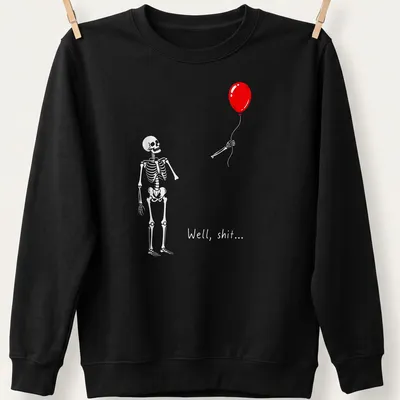 A cartoon skeleton holds a red balloon with the phrase 'Well, shit...' — printed on a unisex sweatshirt