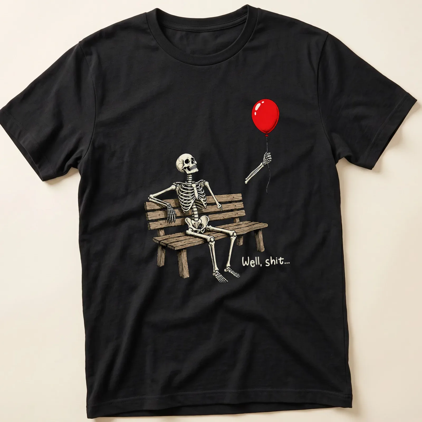 Cartoon skeleton on a bench holding a red balloon with humorous text saying 'Well, shit...' — printed on a unisex t-shirt