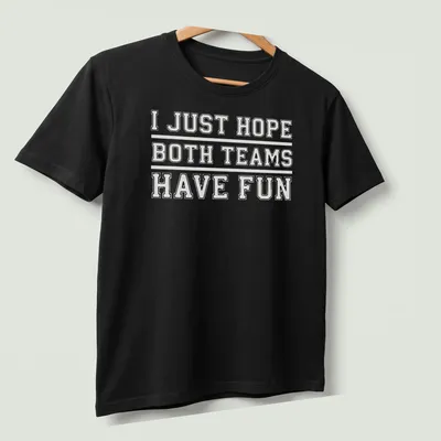 Bold text reading 'I JUST HOPE BOTH TEAMS HAVE FUN' on a sports fan — printed on a unisex t-shirt (angled view)