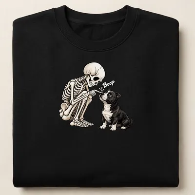 Cartoon Staffordshire Bull Terrier with skeleton, with the word Boop in black and beige — printed on a unisex sweatshirt