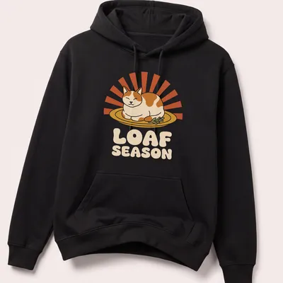 Humorous Thanksgiving Cat Loaf Season t-shirt with retro printed text and cartoon cat — printed on a unisex hoodie