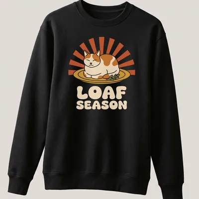 Humorous Thanksgiving Cat Loaf Season t-shirt with retro printed text and cartoon cat — printed on a unisex sweatshirt