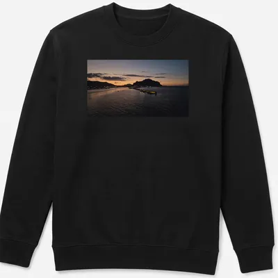 Photographic print of a tranquil harbor at sunset with golden and blue hues — printed on a unisex sweatshirt