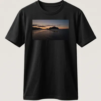 Photographic print of a tranquil harbor at sunset with golden and blue hues — printed on a unisex t-shirt