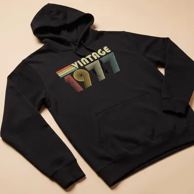 Distressed T-shirt with 'VINTAGE 1977' text in red, green, yellow, and cream colors — printed on a unisex hoodie
