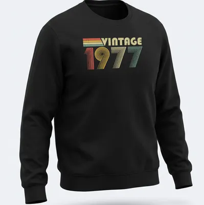 Distressed T-shirt with 'VINTAGE 1977' text in red, green, yellow, and cream colors — printed on a unisex sweatshirt