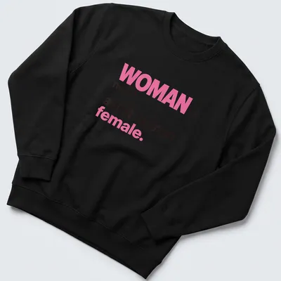 Bold typography t-shirt declaring 'WOMAN noun. adult human female.' in pink and black — printed on a unisex sweatshirt