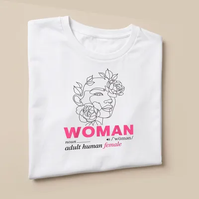 Floral woman face design surrounding the text defining 'woman' in line art style — printed on a unisex t-shirt (angled view)